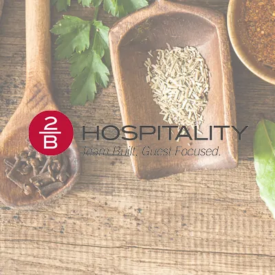 2B Hospitality logo over a background of spices and herbs