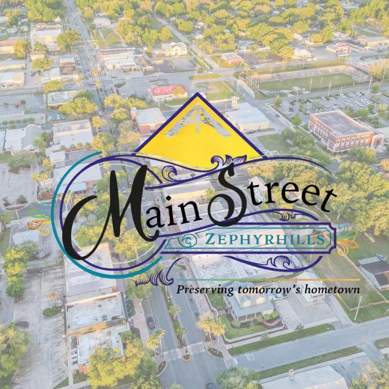 Main Street Zephyrhills logo over an aerial photo of downtown Zephyrhills