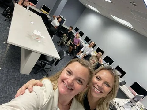 Two colleagues taking a selfie in the HCP Associates office
