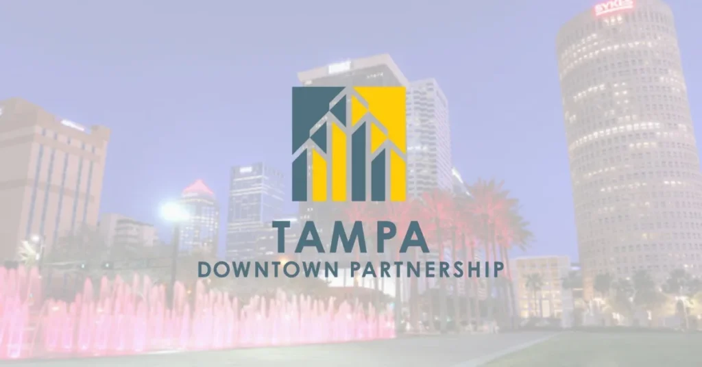 Tampa Downtown Partnership logo over a blurred night skyline