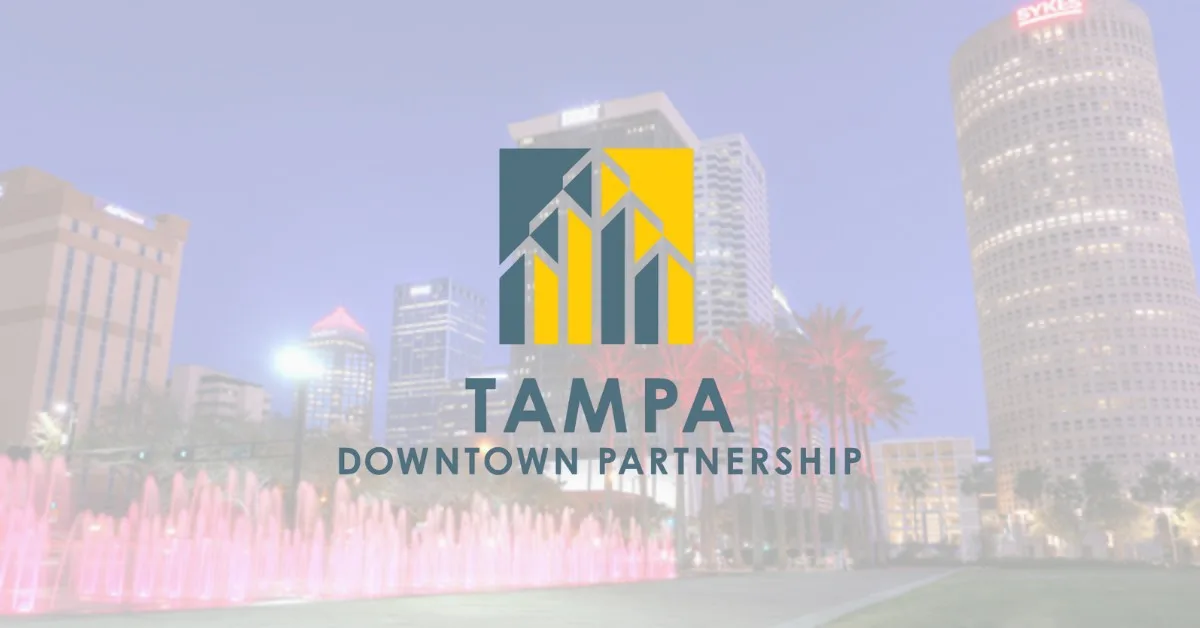 Tampa Downtown Partnership logo over a blurred night skyline