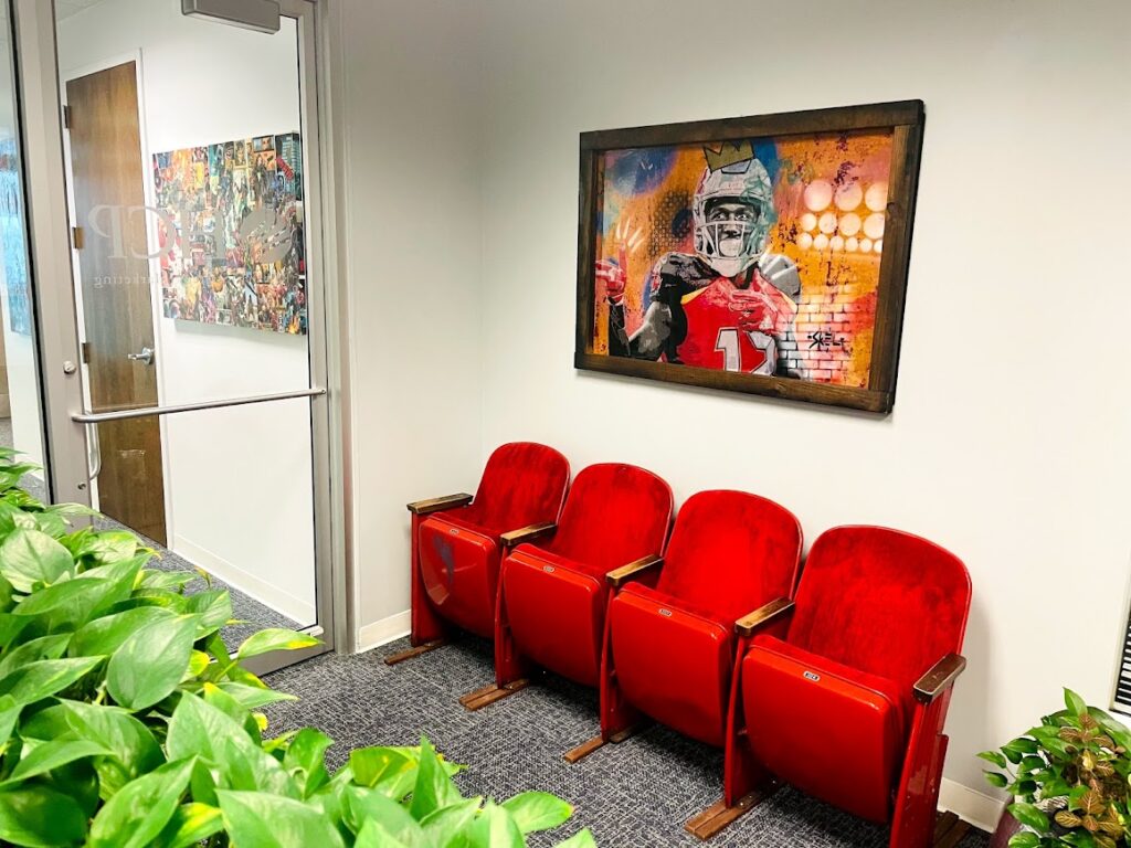 HCP Associates office entrance with red vintage theater seating and framed art