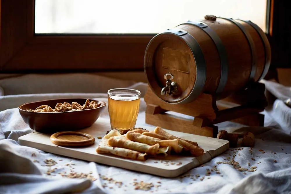 Table setting with a wine barrel, a filled glass, and bread