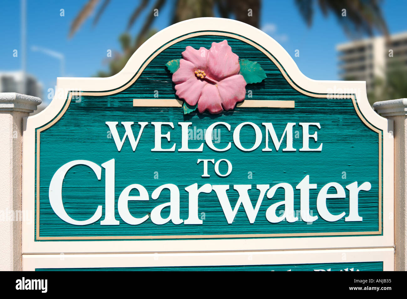 'Welcome to Clearwater' road sign with a hibiscus flower