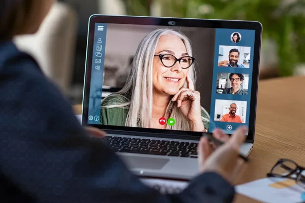 Woman on a video call with multiple colleagues