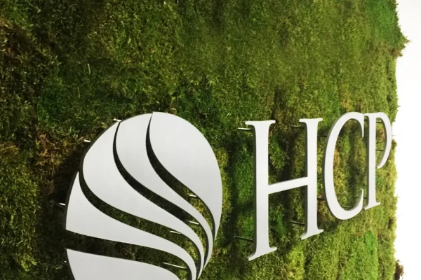 HCP Associates logo mounted on a living moss wall