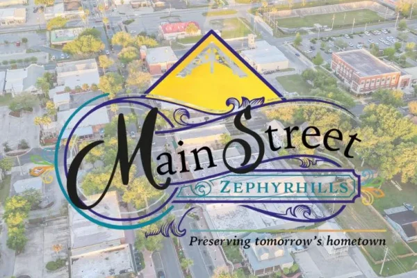 Main Street Zephyrhills logo over an aerial photo of downtown Zephyrhills