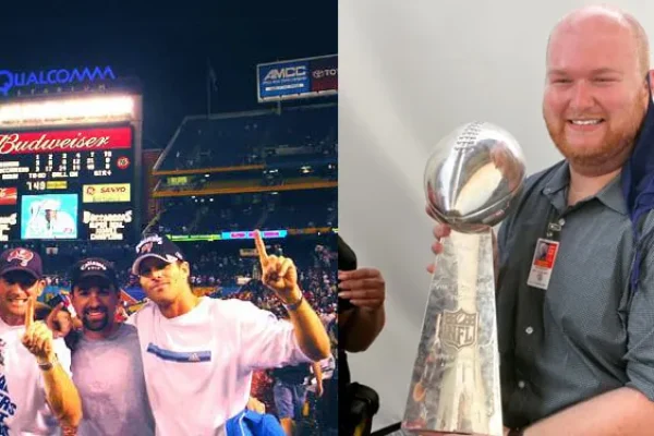 A man celebrating with a championship trophy at a stadium