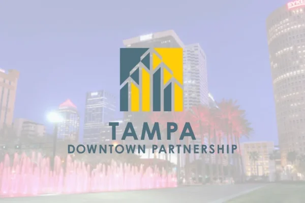 Tampa Downtown Partnership logo over a blurred night skyline