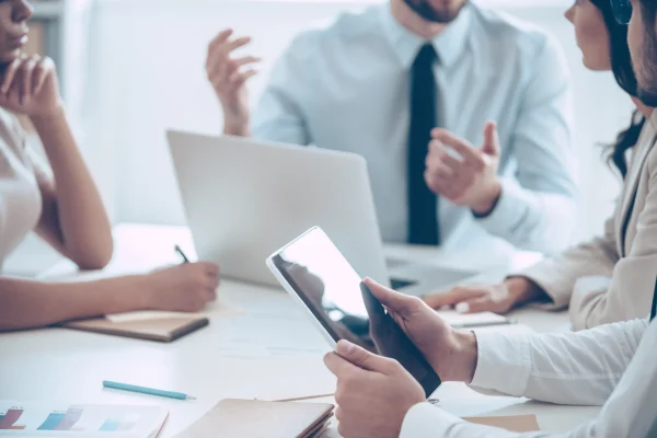 Business people reviewing a tablet in a meeting