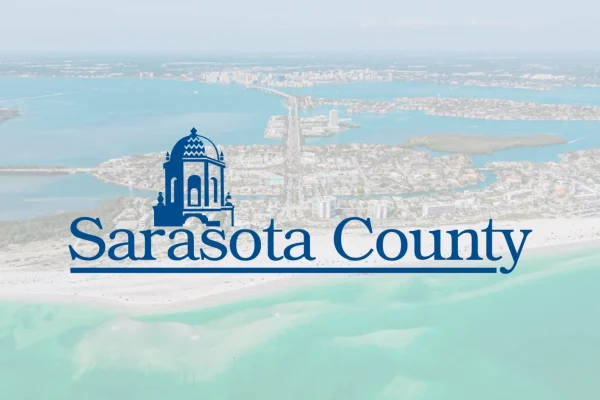 Sarasota County logo over an aerial photo of the coastline