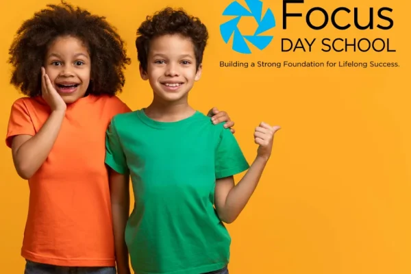 Two children giving a thumbs up next to the Focus Day School logo and tagline